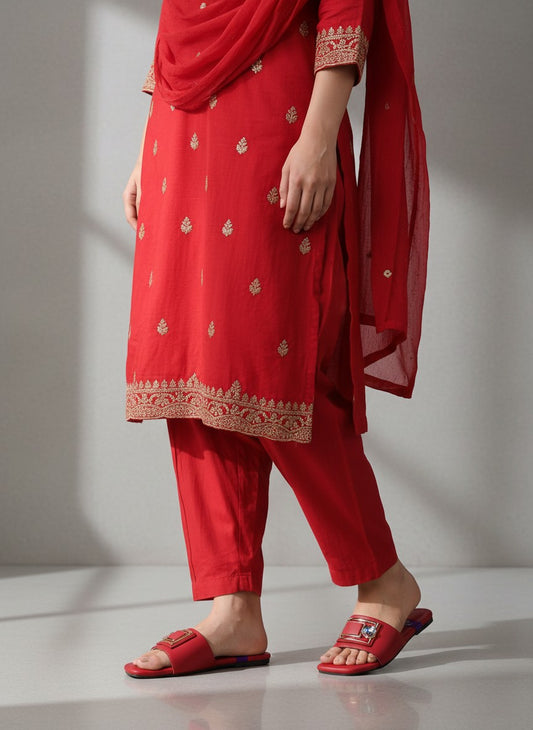 My Store 2 red slide sandals featuring a gold buckle and crystal embellishment worn with a matching red embroidered suit