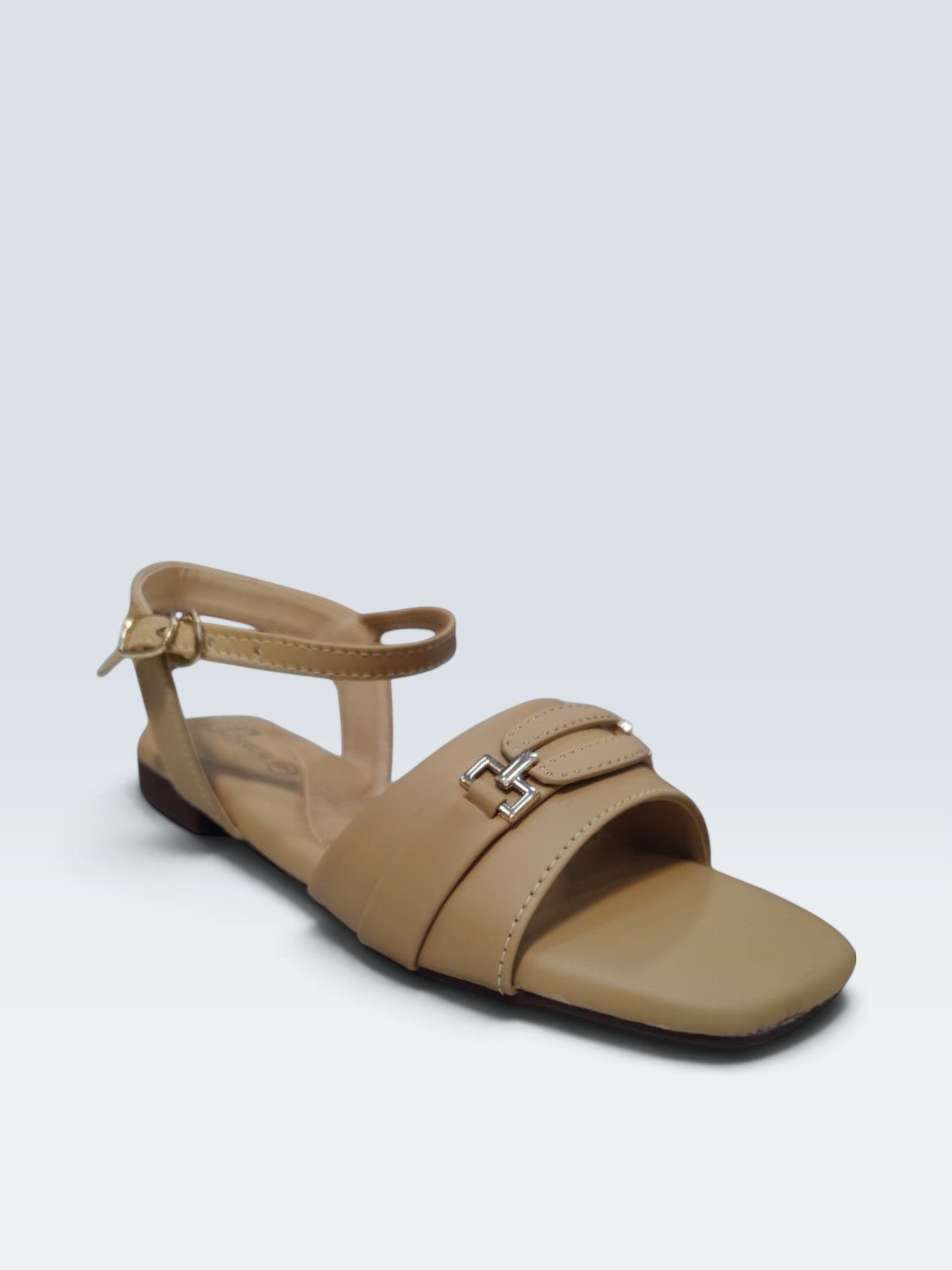 My Store 2 beige synthetic leather flat sandals with square toe, ankle strap, and metallic buckle detail.