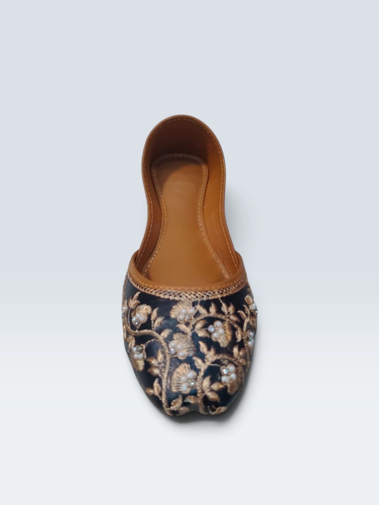 My Store 2 black jutti flats featuring intricate gold floral embroidery and delicate pearl embellishments.