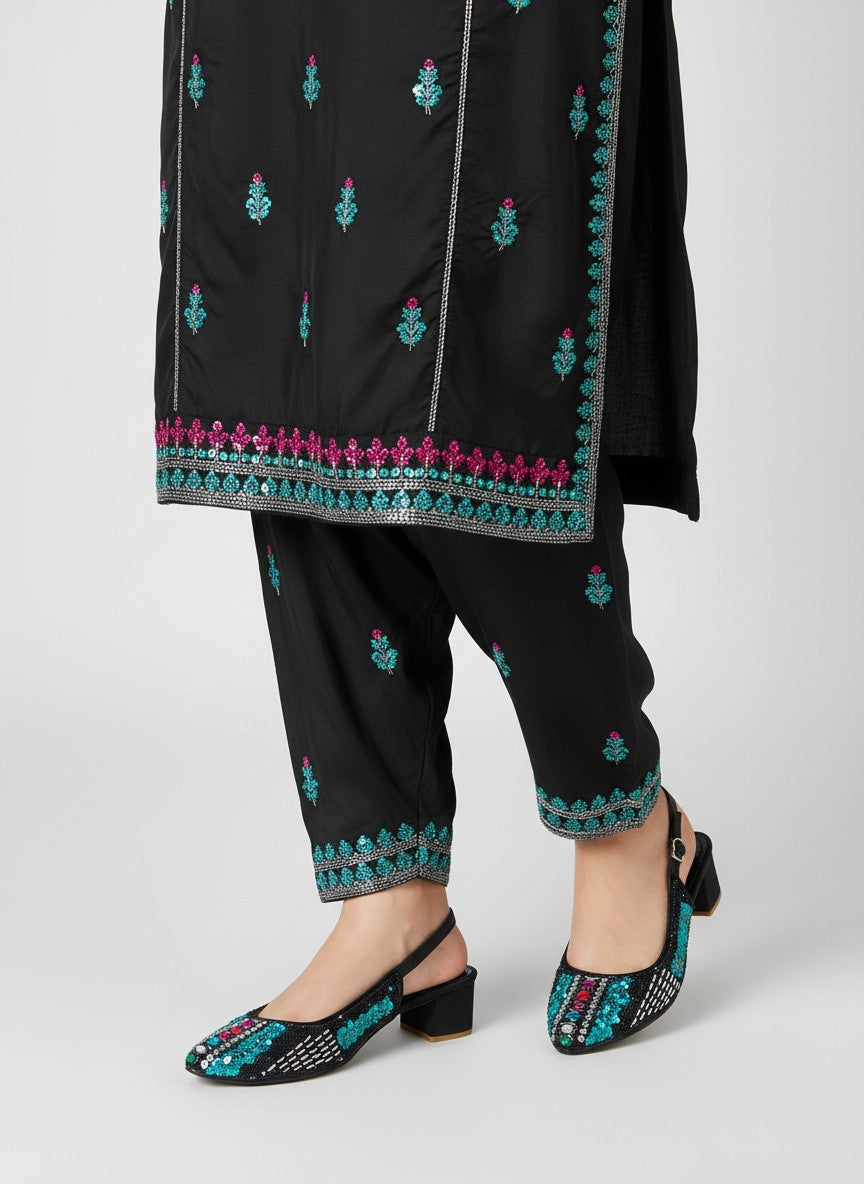 My Store 2 black slingback block heel sandals with turquoise and crystal embellishments worn with matching trousers.