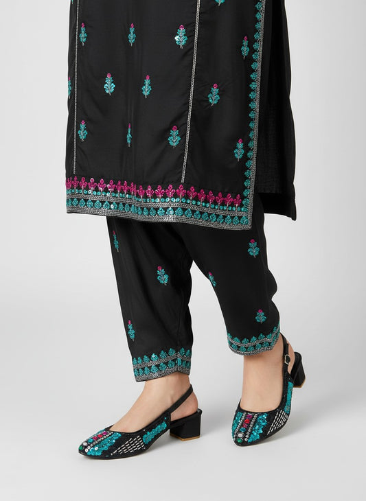My Store 2 black slingback block heel sandals with turquoise and crystal embellishments worn with matching trousers.