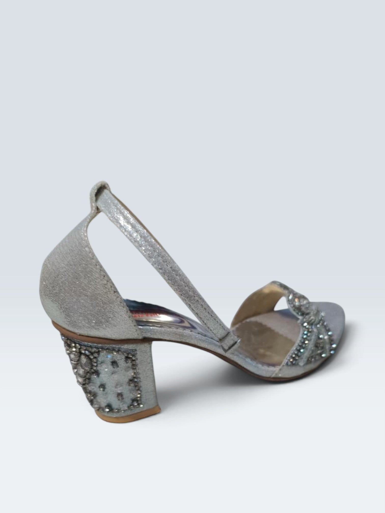 My Store 2 silver metallic block heel sandals with crystal embellishments on the strap and heel, side view.