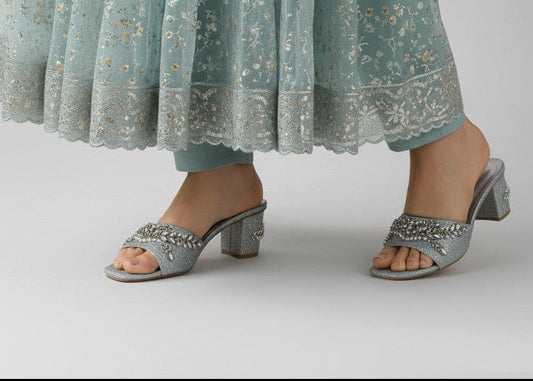 My Store 2 silver glitter block heel mules with crystal and pearl embellishments worn with a floral embroidered skirt